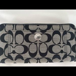 Coach black zip around wallet. Barely used and in excellent condition.